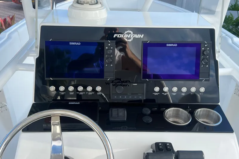Slide: The Image of 2002 Fountain 29 Center Console dashboard with dual Simrad displays and controls. - 8