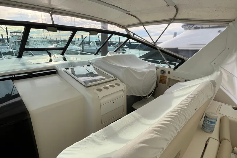 Slide: The Image of 1994 Tiara Yachts 4000 Express cockpit with covered controls and marina view. - 10