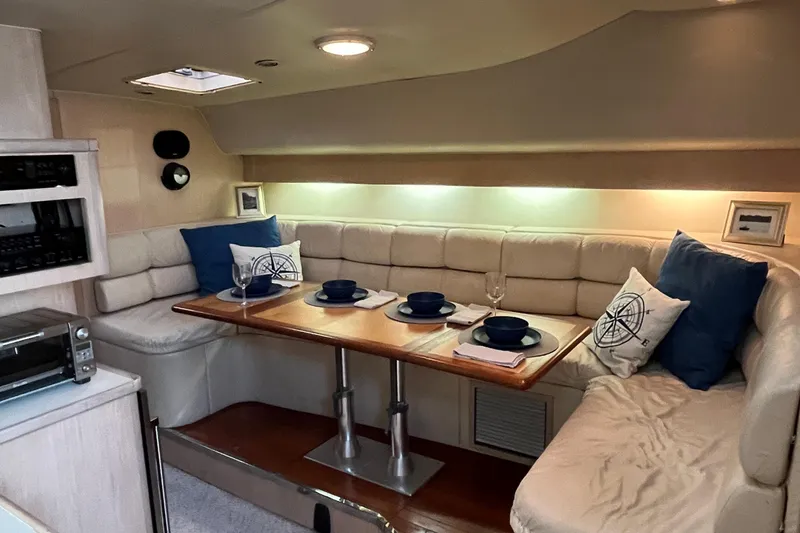 Slide: The Image of 1994 Tiara Yachts 4000 Express interior with cozy dining area and elegant table setting. - 16