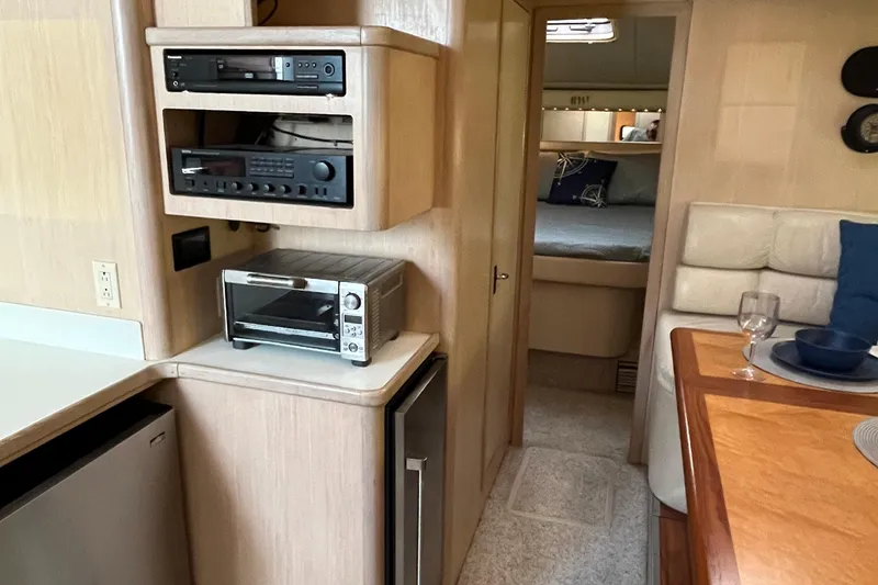 Slide: The Image of 1994 Tiara Yachts 4000 Express interior with kitchen appliances and cozy cabin view. - 17