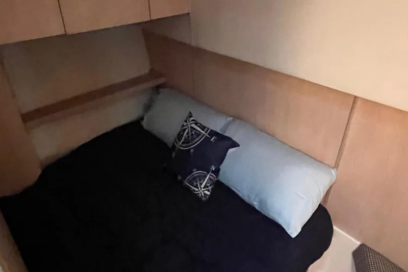 Slide: The Image of Cozy cabin interior of 1994 Tiara Yachts 4000 Express with nautical-themed pillow. - 19