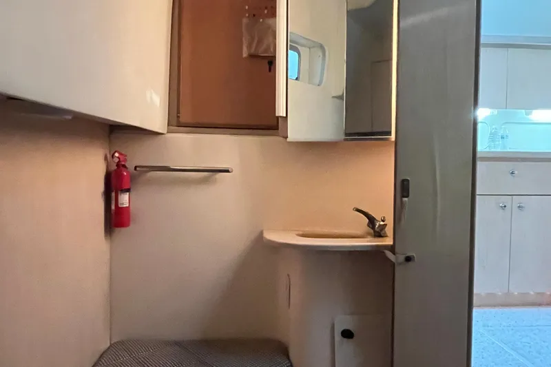 Slide: The Image of 1994 Tiara Yachts 4000 Express interior with sink, mirror, and fire extinguisher. - 20