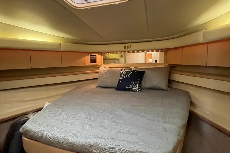 Slide: The Image of 1994 Tiara Yachts 4000 Express cabin interior with bed and nautical-themed decor. - 21