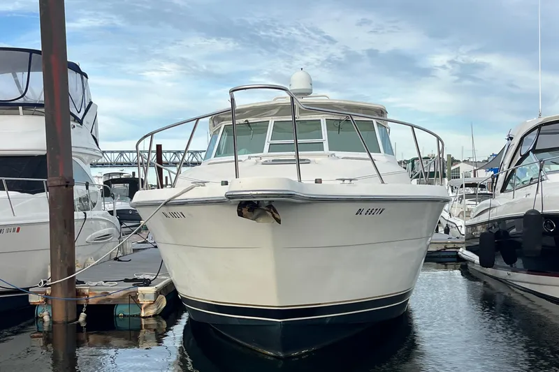 Slide: The Image of 1994 Tiara Yachts 4000 Express docked at marina under cloudy sky. - 3