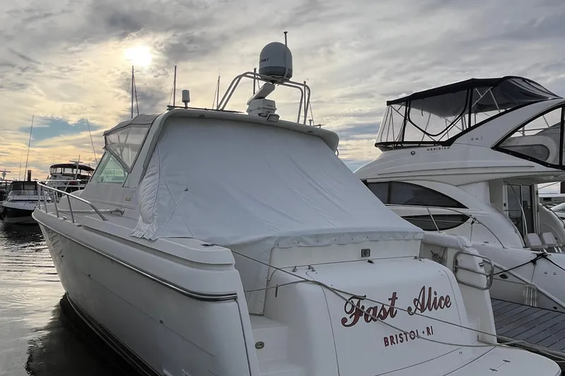 Slide: The Image of 1994 Tiara Yachts 4000 Express docked at marina under cloudy sky. - 8