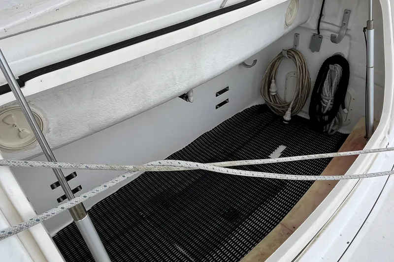 Slide: The Image of 1994 Tiara Yachts 4000 Express storage compartment with ropes and black mat. - 9