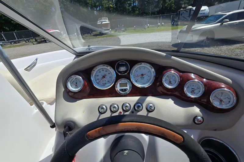 Slide: The Image of Dashboard of a 2011 Tahoe Q5i boat with gauges and steering wheel. - 18