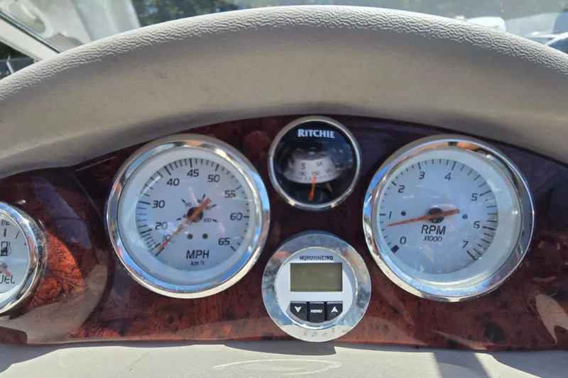 Slide: The Image of Dashboard of a 2011 Tahoe Q5i boat with speedometer, RPM gauge, and compass. - 19