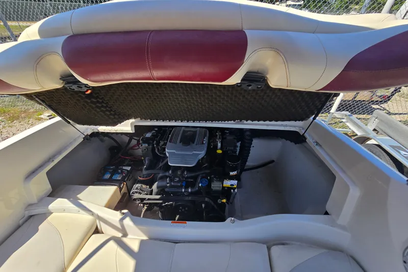 Slide: The Image of 2011 Tahoe Q5i boat engine compartment with open hatch, revealing engine and battery. - 20