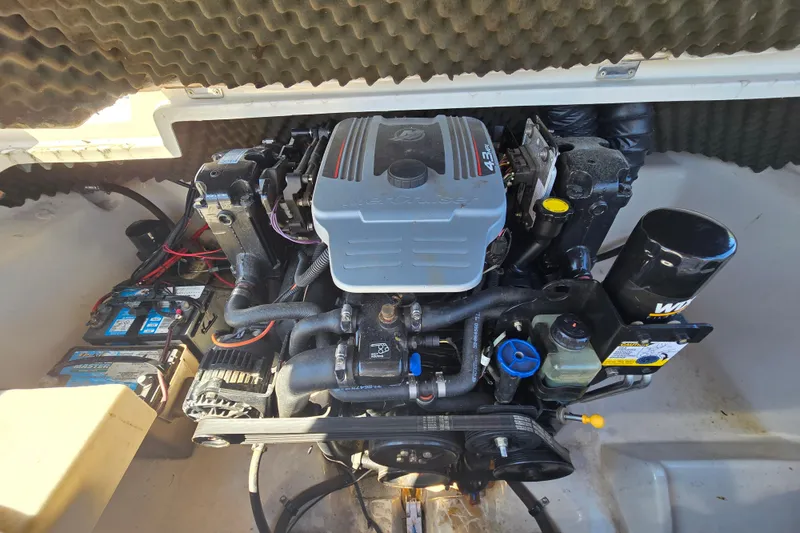 Slide: The Image of 2011 Tahoe Q5i engine compartment with visible components and wiring. - 21