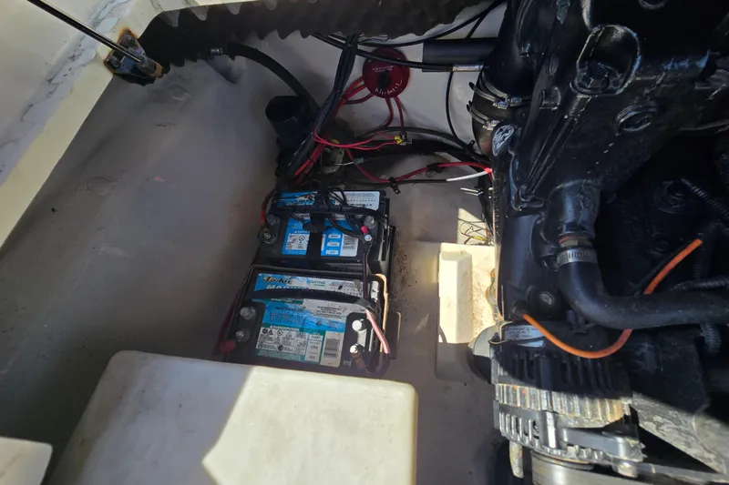 Slide: The Image of 2011 Tahoe Q5i boat engine compartment with dual batteries and wiring. - 22