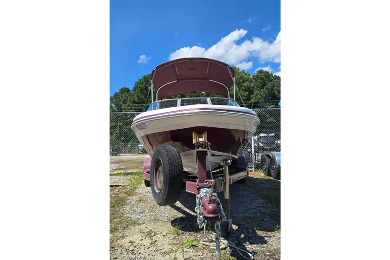 Slide: The Image of 2011 Tahoe Q5i boat on trailer, parked outdoors under blue sky. - 3