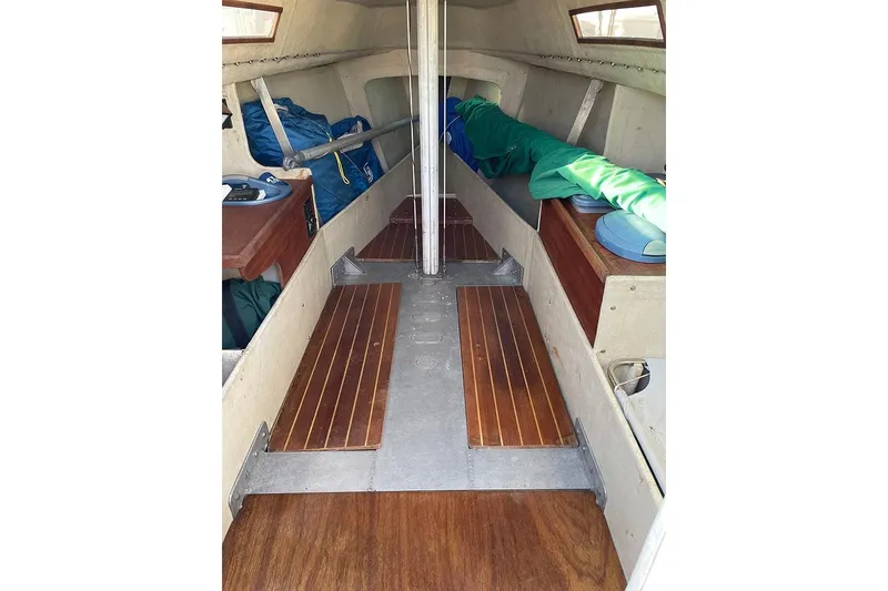 Slide: The Image of Interior of 1985 S2 K sailboat with wooden flooring and storage compartments. - 10