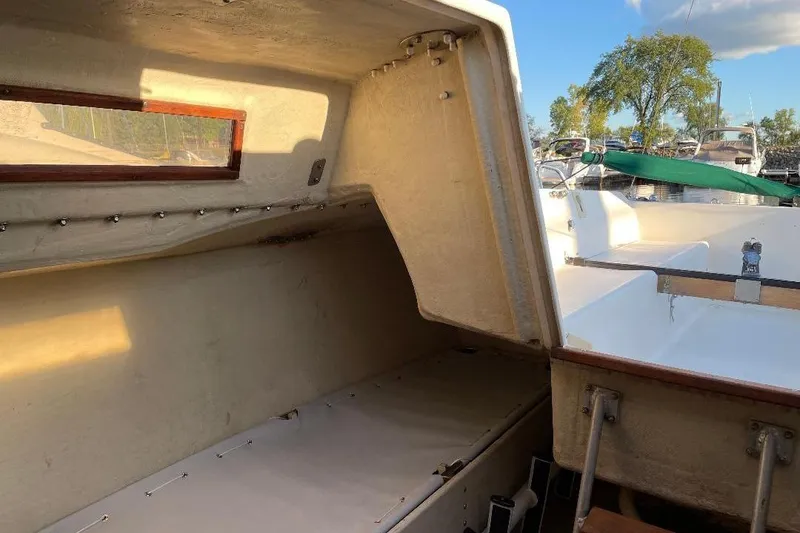 Slide: The Image of 1985 S2 K model boat interior with open hatch, docked under blue sky. - 15