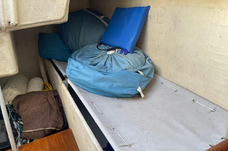 Slide: The Image of Interior of 1985 S2 K sailboat with storage and blue cushions. - 16