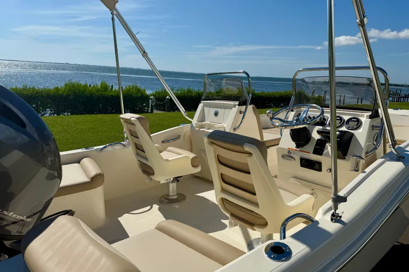 Slide: The Image of 2026 Scout 175 Sport Dorado boat interior with steering wheel, seats, and ocean view. - 11