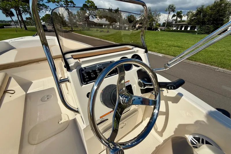 Slide: The Image of 2026 Scout 175 Sport Dorado boat interior with steering wheel and control panel. - 16