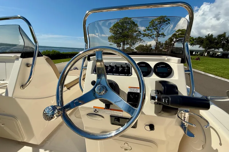 Slide: The Image of 2026 Scout 175 Sport Dorado boat dashboard with steering wheel and controls. - 17