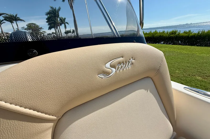 Slide: The Image of 2026 Scout 175 Sport Dorado boat seat with logo, scenic waterfront view. - 24