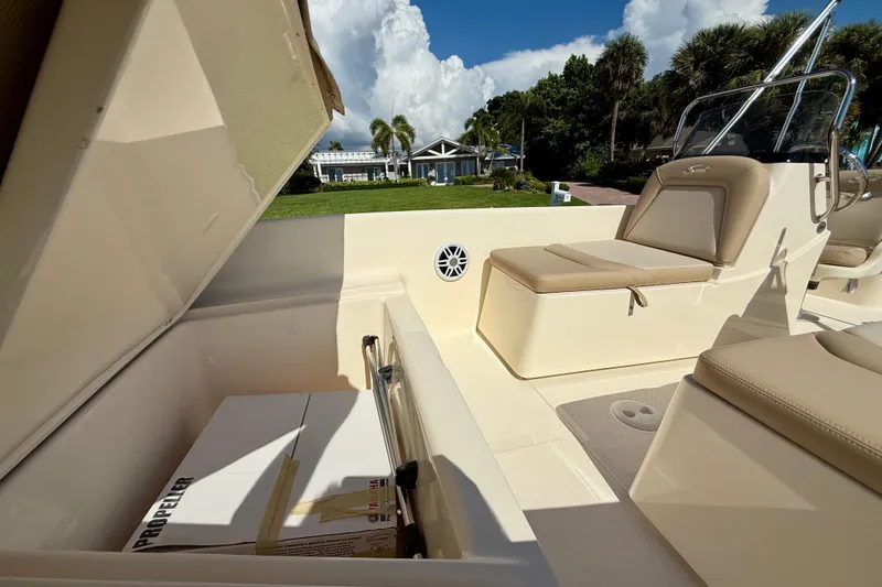 Slide: The Image of 2026 Scout 175 Sport Dorado boat interior with seating and storage compartment open. - 26