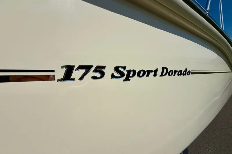 Slide: The Image of 2026 Scout 175 Sport Dorado boat logo on hull, close-up view. - 28