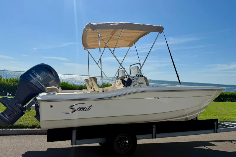 Slide: The Image of 2026 Scout 175 Sport Dorado boat with Yamaha engine, parked near scenic waterfront. - 3