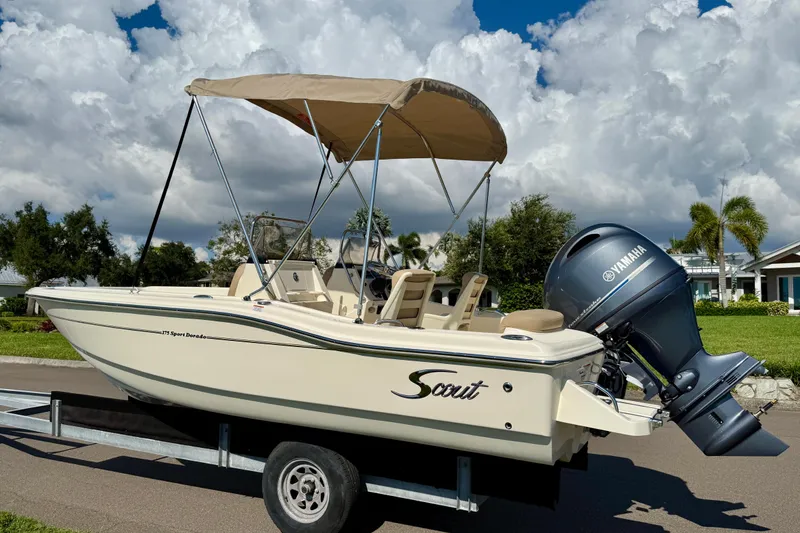 Slide: The Image of 2026 Scout 175 Sport Dorado boat on trailer with Yamaha engine, under cloudy sky. - 4