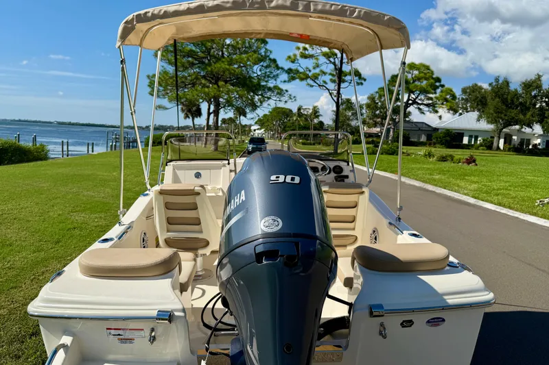 Slide: The Image of 2026 Scout 175 Sport Dorado boat with Yamaha engine, parked by a scenic waterfront. - 7