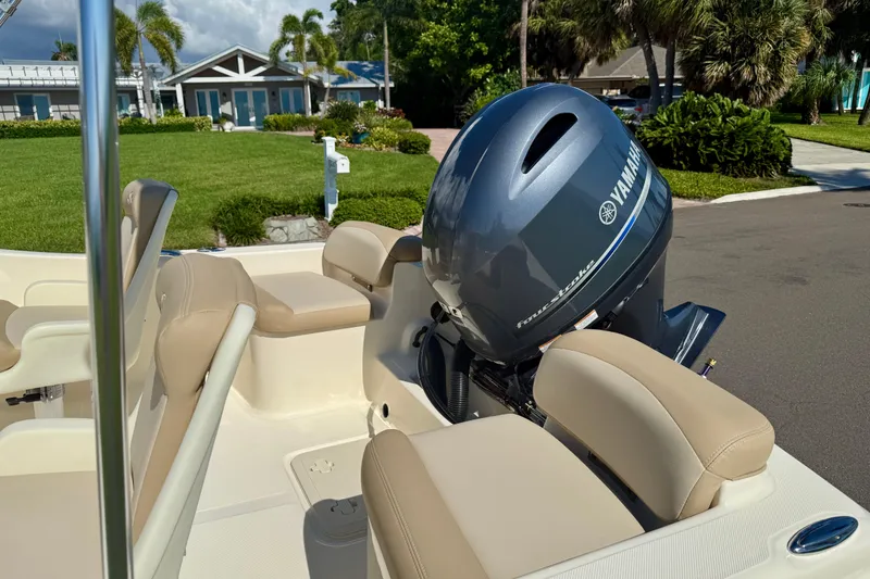 Slide: The Image of 2026 Scout 175 Sport Dorado boat with Yamaha outboard motor, beige seating, and lush background. - 9