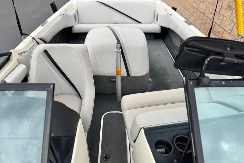 Slide: The Image of 1999 Malibu Sunsetter LX boat interior with white seating and open windshield. - 13