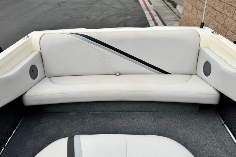 Slide: The Image of 1999 Malibu Sunsetter LX boat interior with white seating and gray carpet. - 15
