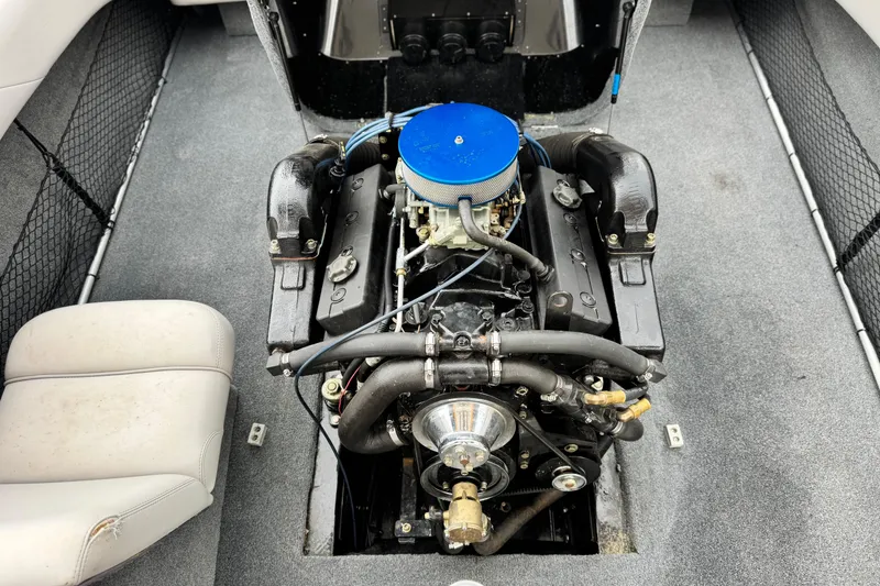 Slide: The Image of 1999 Malibu Sunsetter LX engine compartment with blue air filter and detailed components. - 17