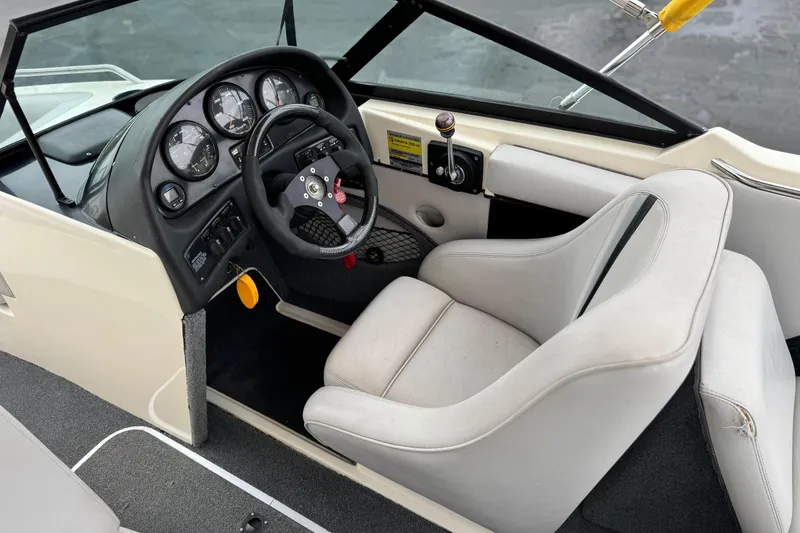 Slide: The Image of 1999 Malibu Sunsetter LX boat interior with steering wheel and dashboard controls. - 24