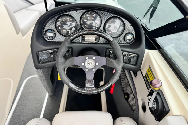 Slide: The Image of 1999 Malibu Sunsetter LX boat dashboard with steering wheel and instrument panel. - 25