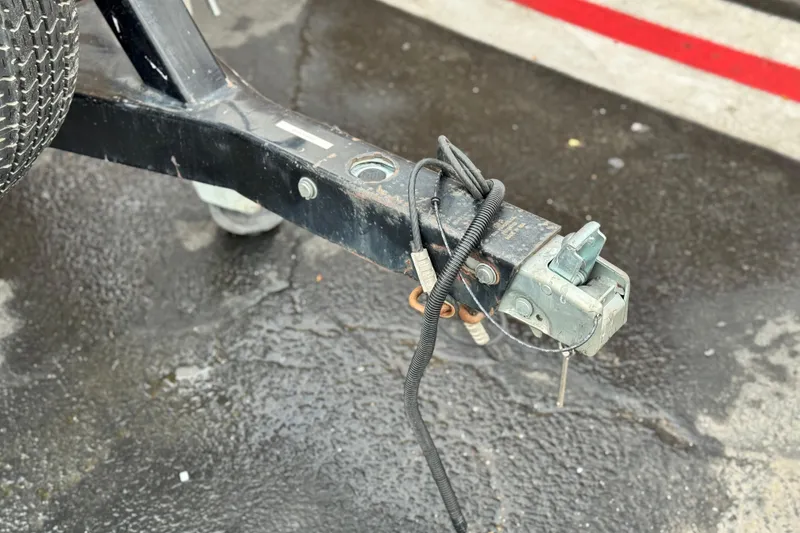 Slide: The Image of Trailer hitch of a 1999 Malibu Sunsetter LX on wet pavement. - 27