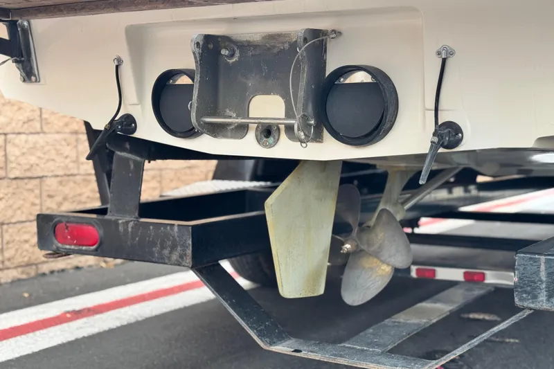 Slide: The Image of 1999 Malibu Sunsetter LX boat on trailer, showing propeller and rear details. - 7