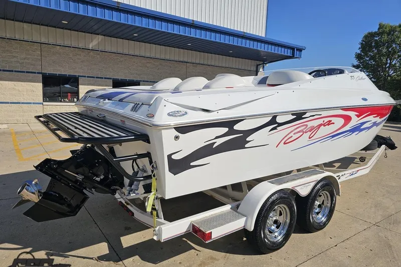 Slide: The Image of 2005 Baja 23 Outlaw speedboat on trailer, featuring sleek design and vibrant graphics. - 14