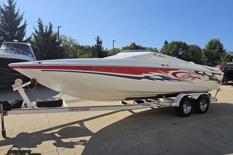 Slide: The Image of 2005 Baja 23 Outlaw speedboat on trailer, featuring sleek design and vibrant graphics. - 23