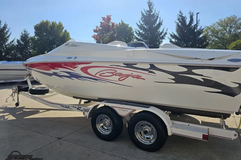 Slide: The Image of 2005 Baja 23 Outlaw speedboat on trailer, featuring dynamic graphics and sleek design. - 29