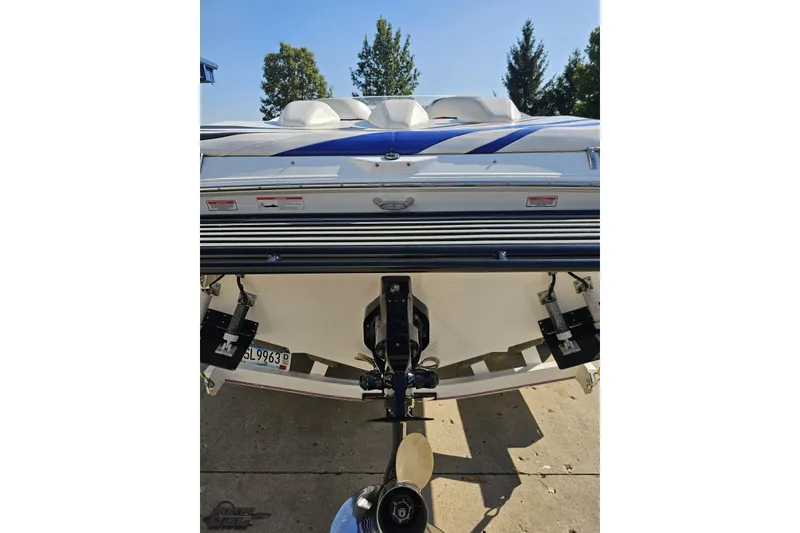 Slide: The Image of Rear view of a 2005 Baja 23 Outlaw boat with blue and white design. - 34