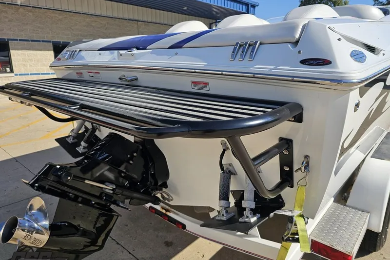Slide: The Image of 2005 Baja 23 Outlaw boat rear view with swim platform and outboard motor. - 35