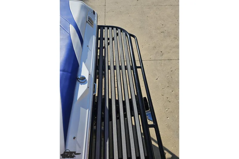 Slide: The Image of 2005 Baja 23 Outlaw boat with blue and white detailing, viewed from above. - 37