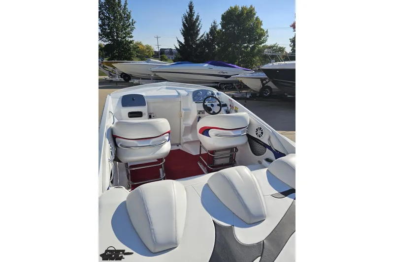 Slide: The Image of 2005 Baja 23 Outlaw boat interior with white seating and steering wheel. - 39