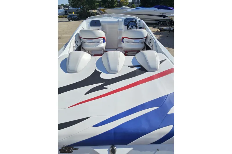Slide: The Image of 2005 Baja 23 Outlaw boat interior with vibrant red, blue, and black accents. - 40