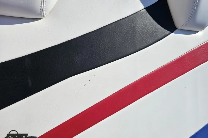 Slide: The Image of 2005 Baja 23 Outlaw boat seat with black and red stripes on white upholstery. - 42