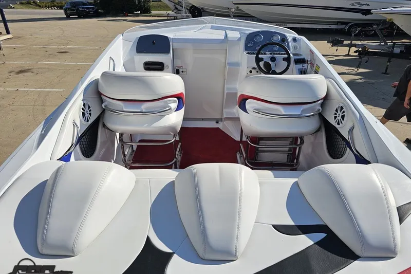 Slide: The Image of 2005 Baja 23 Outlaw boat interior with white seating and dashboard. - 43