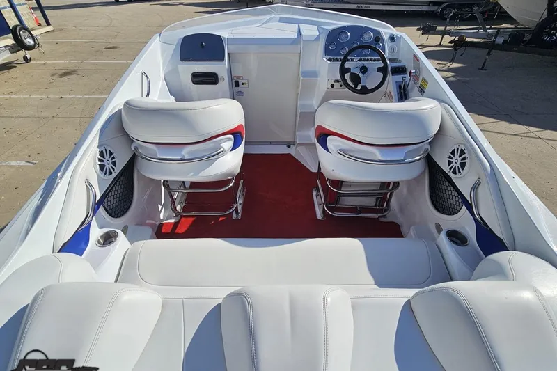 Slide: The Image of 2005 Baja 23 Outlaw boat interior with white seating and red accents. - 44