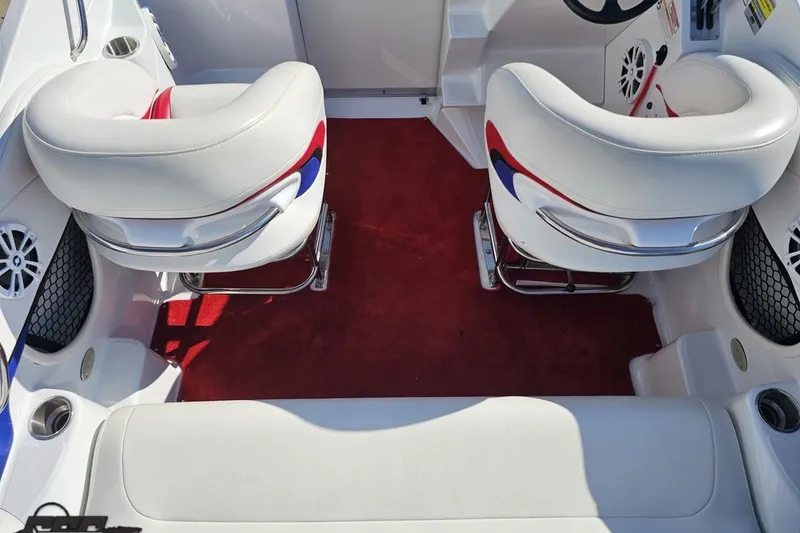 Slide: The Image of Interior of a 2005 Baja 23 Outlaw boat with white and red seating. - 46