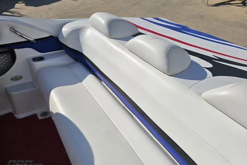 Slide: The Image of 2005 Baja 23 Outlaw boat interior with white seating and colorful accents. - 48