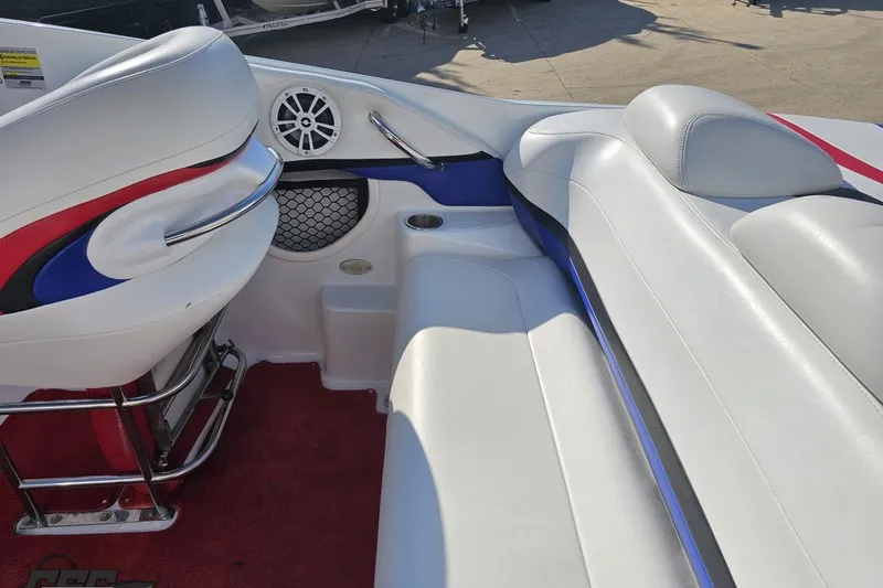 Slide: The Image of Interior of a 2005 Baja 23 Outlaw boat with white and red seating. - 49